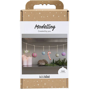 Packaging for 'Modelling Created by you' with Christmas-themed decorations on a white background.