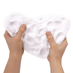 White clay material held by hands on a white background