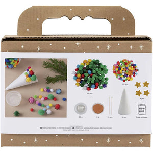 Craft kit packaging with colorful pom-poms, green branches, and a cardboard handle on a white background.