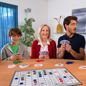 Family playing a board game together in a living room.