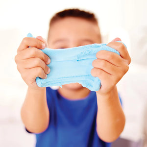 Child holding blue slime in front of their face against a white background