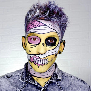 Person with colorful snazaroo face paint and purple hair against a white background