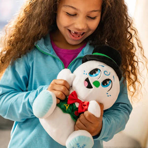 Child holding a plush Razzle the snowman with a red bowtie and green christmas waistcoat