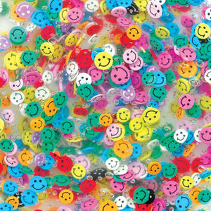 Colorful smiley face beads scattered on a clear background