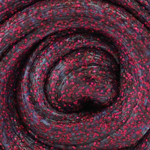 Close-up of a roll of red and black glittery fabric.