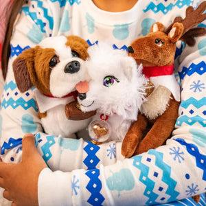 A child's arms around the Elf Pets Plush Toys including the white arctic fox, brown reindeer, and dg