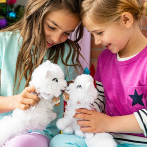 two girls playing outside with the Elf Pets arctic fox white plush toys. 