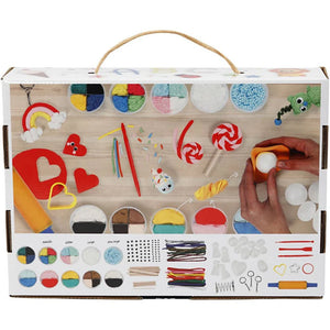 Children's clay set with various tools and colors on a wooden surface.