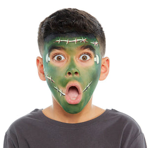 Person with green snazaroo face paint resembling a monster with barbed wire, wearing a gray shirt on a white background
