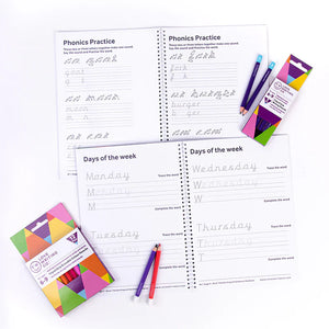 Educational handwriting workbook with phonics practice pages and coloured pencils on a white background