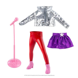 The Elf on the Shelf MagiFreez - Polar Pop Star outfit set with silver jacket, red leggings, purple skirt, pink microphone, and pink high heels on a white background.