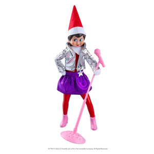 Elf on the Shelf doll with red hat, silver jacket, purple skirt, and pink microphone on a white background