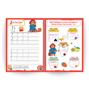 Educational book open to a page with a letter 'J' activity and Paddington Bear illustrations.