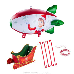the elf on the shelf red and white blimp, sleigh with a green interior and other accessories