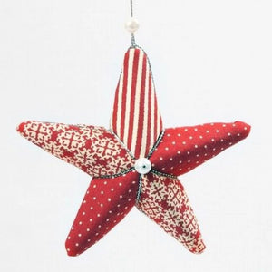 Red and white patterned Polystyrene star ornament on a white background