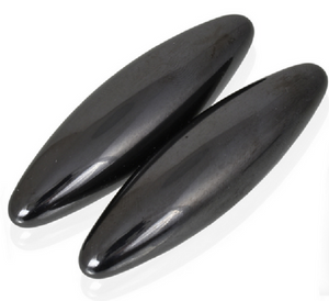 Two black oval-shaped magnets on a white background