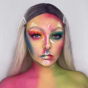 Person with colorful makeup and snazaroo face paint on a plain background