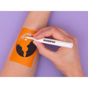 Person applying Snazaroo face paint using a stencil on their arm with a purple background
