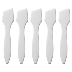 Set of five white face painting spatulas on a white background