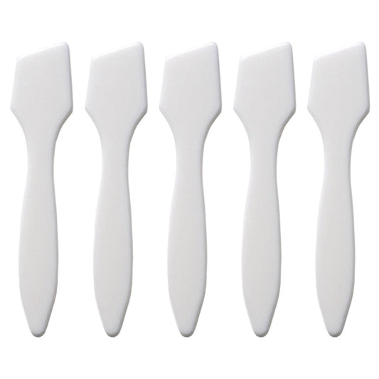 Set of five white face painting spatulas on a white background