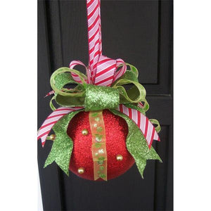 Decorative Christmas ornament with a red ball, green bow, and candy cane on a black background